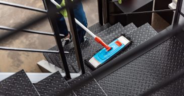 cropped view of cleaner washing stairs with mop